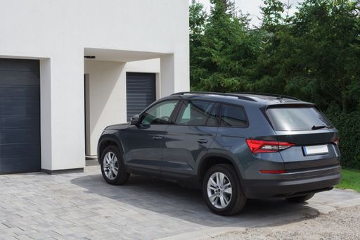 A crossover car parked in front of the family home.