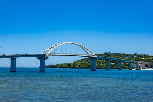 A long bridge over beautiful blue water in Okinawa, Japan.