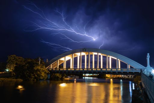 A breathtaking lightning storm at night over the bridge and San Juan river. Matanzas, Cuba.