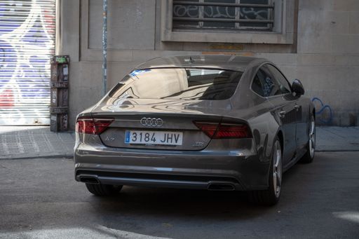 A dull and grayish appearance of a luxurious Audi A7 saloon parked on the city street