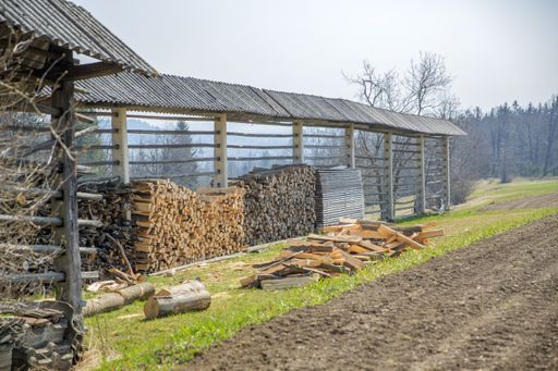 A selective focus shot of woodpiles in a rural area