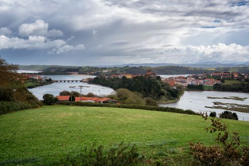 A scenic view of San Vicente de la Barquera in Spain on a cloudy day