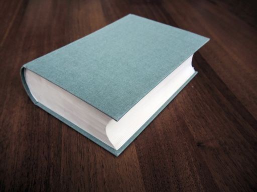 A closeup of a green blank cover of big book on the table