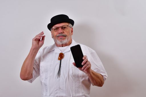 A handsome American old man is using his cellphone