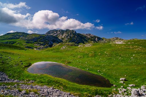 A stunning landscape of mountains and a small pond under them, Durmitor National Park, Montenegro