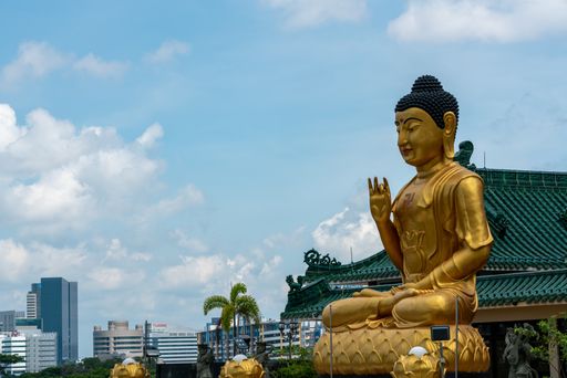 Singapore, March 30, 2021: Statue  Singapore Buddhist Youth Mission against view of  Clementi