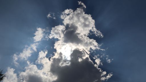 A white wispy cloud against a blue sky