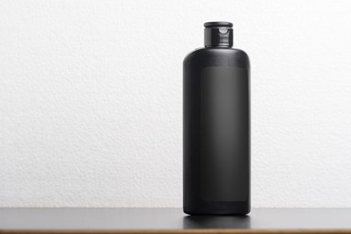 A hair shampoo bottle in front of a light gray background, editable mock-up series template ready for your design, selection path included.