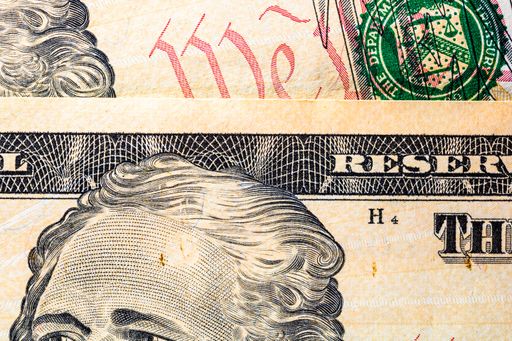 A selective focus on the detail of USD banknotes. Close up macro detail of United States Dollars banknotes.