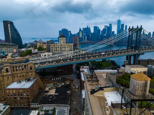An aerial view of both the Manhattan and Brooklyn Bridges on a cloudy morning, seen from Brooklyn.