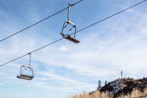 An empty ski lift against the backdrop of a bright blue sky
