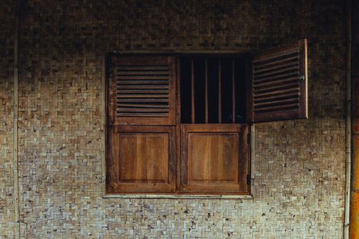 The wooden windows with bars of old vintage building, Indonesia