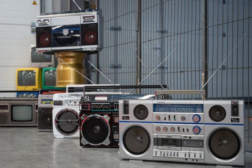 Detail of some old gray and black radio cassettes in a workshop
