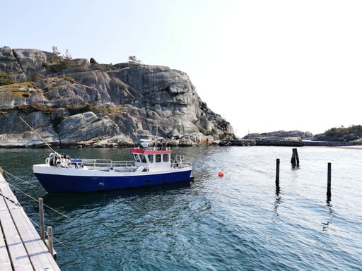 A beautiful shot of a boat on the harbor in Kjerringvik, Norway