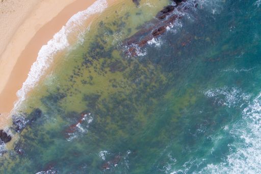 An aerial view of a rocky beach shore