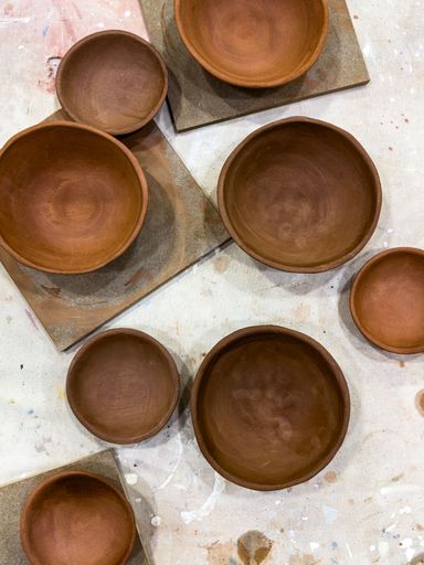 Greenware ceramic plates and bowls from various clay bodies