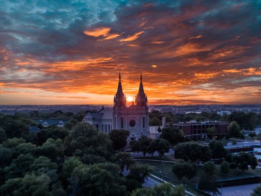 Sun in between two spires of an old Cathedral in the Midwest