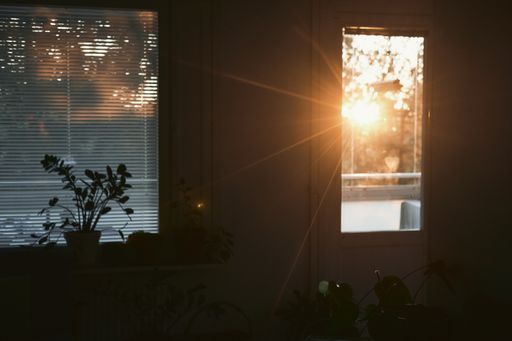 A closeup shot of the sunset sun rays coming through the door window