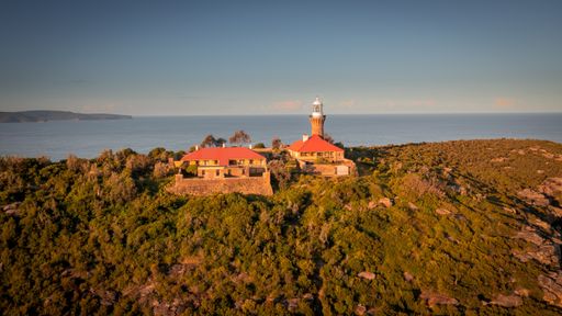 An aerial view of the Barranjoey lighthouse in Sydney, Australia during sunset