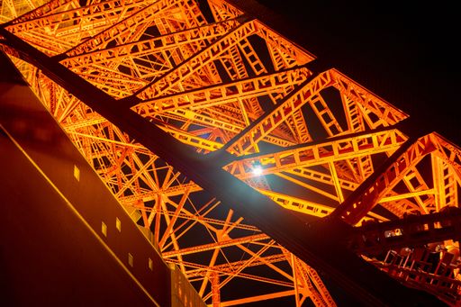 Closeup of one of the legs of Tokyo Tower in Tokyo, Japan at night.