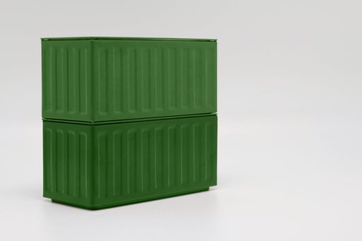 A close-up of green shipping containers stacked on top of one another