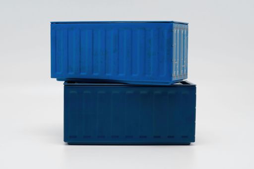 A stack of blue shipping containers against a white background