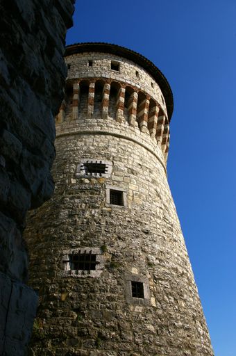A low-angle shot of the castle of Brescia against the blue sky