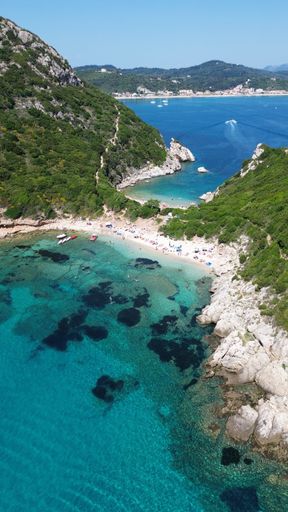 An aerial view of the rocky shoreline of Corfu, Greece with its crystal clear blue ocean waters.