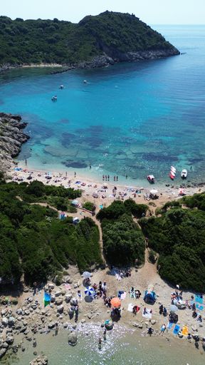 An aerial view of the rocky shoreline of Corfu, Greece with its crystal clear blue ocean waters.