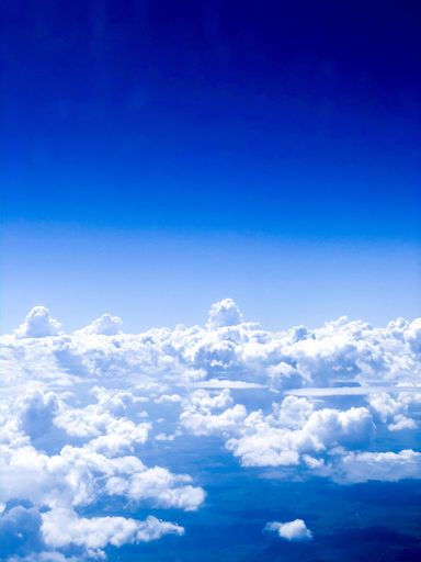 A beautiful cloudscape. Aerial view of puffy cumulus clouds in the blue sky