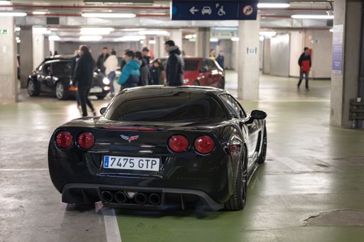 Rear view of a classic American sports car, the black Chevrolet Corvette C6 Z51 parked in an underground parking lot