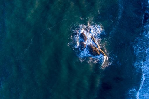 zenithal aerial view of rocks near the coast in the atlantic ocean