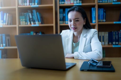 A female professor teaching an online class at the library