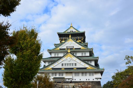 A low angle of Osaka castle against cloudy sky in Japan