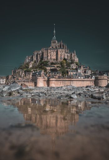 A picturesque view of Mont Saint Michel, an island commune in France, from the banks of the river