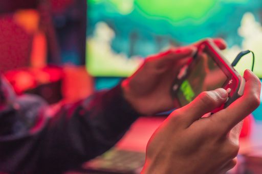A closeup shot of a young gamer male playing on his phone