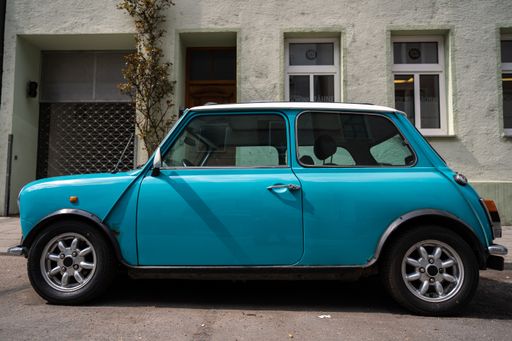 Oldtimer is parked in front of an old house in Munich. Vintage car in german city
