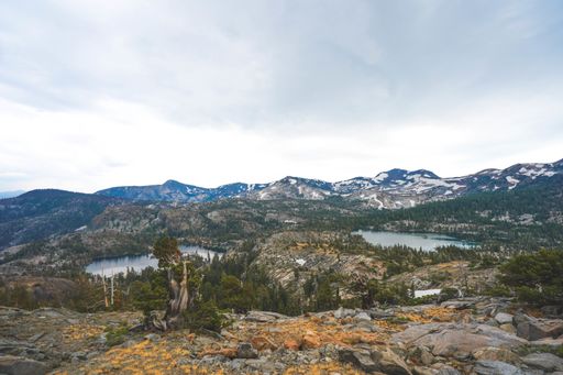 An ariel shot of cliffs and mountains with trees growing around them near Lake Tahoe, CA