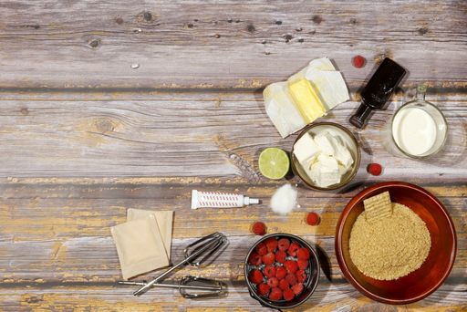 A top view of baking ingredients and equipment on a wooden surface