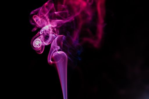 Random shapes of colored smoke on black background