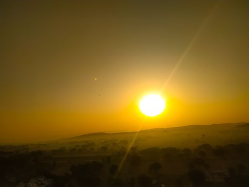 The beautiful yellow sun rising over the field
