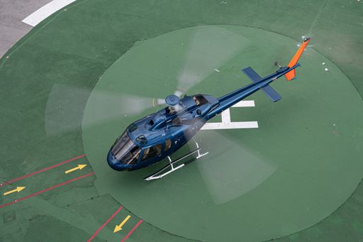 Barcelona, Spain; January 8, 2021: Blue helicopter flying over the city of Barcelona. Aerospatiale AS 355F-2 Ecureuil 2