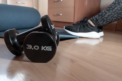 A woman training at home with dumbbells