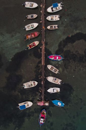 The aerial shot of fishing boats docked on the pier