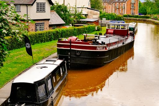 Historic village Worsley Manchester with barge repair yard, inland waterway, boats, and mining heritage.