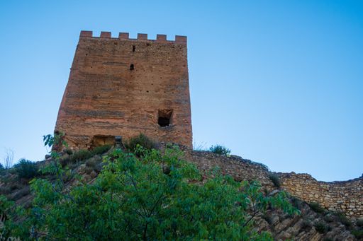 A low angle shot of Sot de Chera Castle under a clear blue sky