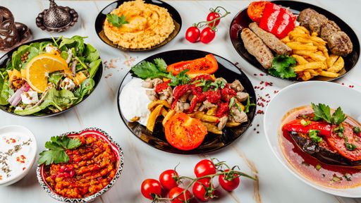 A closeup shot of healthy different dishes with soups and salad on a wooden table