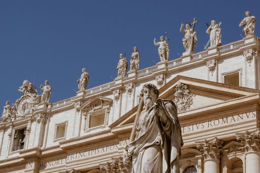 A low angle shot of a beautiful sculpture of a man in St. Peter's Square in the Vatican City, Italy