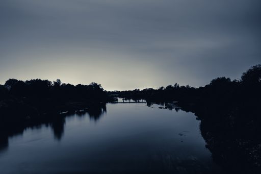 A tranquil evening scene with a lake surrounded by lush vegetation. Limerick, Ireland