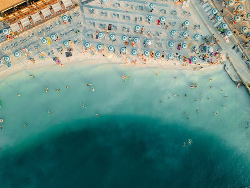 An aerial view o of people enjoying a sunny day at the beach in Selce, Croatia